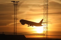 (FILES) In this file photo taken on November 17, 2017 An airplane takes off as the sun sets in Stockholm airport in Sweden. - Saddled with long dark winters, Swedes have for decades been frequent flyers seeking out sunnier climes, but a growing number are changing their ways because of air travel's impact on the climate. (Photo by ludovic MARIN / AFP)LUDOVIC MARIN/AFP/Getty Images