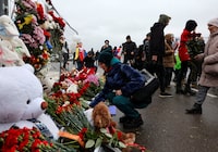 People lay flowers at a makeshift memorial to the victims of a shooting attack at the Crocus City Hall concert venue in the Moscow Region, Russia, March 23, 2024. REUTERS/Yulia Morozova