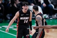 Miami Heat guard Tyler Herro (14) celebrates with Caleb Martin late in the second half Game 2 of the team's NBA basketball first-round playoff series against the Boston Celtics, Wednesday, April 24, 2024, in Boston. (AP Photo/Charles Krupa)
