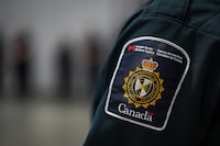 A patch is seen on the shoulder of a Canada Border Services Agency officer's in Tsawwassen, B.C., Friday, Dec. 16, 2022. The Alberta government says it is ending an agreement with Canada Border Services Agency to use provincial correctional centres to house people being detained on immigration matters.THE CANADIAN PRESS/Darryl Dyck