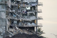 FILE - A giant tarp, bottom, covers a section of rubble at the Champlain Towers South condo building, July 4, 2021, in Surfside, Fla. Federal investigators determining why the Florida condominium tower partially collapsed three years ago, killing 98 people, said Thursday, March 7, 2024, that there were many faulty support columns in the tenant garage that ran below it and the adjoining pool deck. (AP Photo/Lynne Sladky, File)