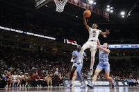 South Carolina guard MiLaysia Fulwiley (12) drives to the basket ahead of North Carolina forward Maria Gakdeng (5) and guard Lexi Donarski (20) during the second half of a second-round college basketball game in the women's NCAA Tournament in Columbia, S.C., Sunday, March 24, 2024. (AP Photo/Nell Redmond)