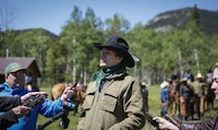 Singer Corb Lund, centre, speaks to media on land proposed for coal mine development in the eastern slopes of the Livingstone range southwest of Longview, Alta., Wednesday, June 16, 2021. Lund is criticizing the province's energy minister for advising its energy regulator to accept initial applications for a coal mine project in the eastern slopes of the southern Rockies. THE CANADIAN PRESS/Jeff McIntosh