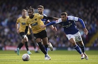 Maidstone United's Lamar Reynolds, left, and Ipswich Town's Dominic Ball battle for the ball during the English FA Cup fourth round  soccer match between Ipswich Town and Maidstone United at Portman Road, in Ipswich, England, Saturday, Jan. 27, 2024. (Joe Giddens/PA via AP)