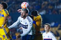 Tristan Blackmon of Canada's Vancouver Whitecaps, left, and Andre-Pierre Gignac of Mexico's Tigres, go for a header during a CONCACAF Champions Cup soccer match in Monterrey, Mexico, Wednesday, Feb. 14, 2024. (AP Photo/Jorge Mendoza)