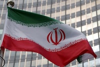 FILE PHOTO: The Iranian flag flutters in front of the International Atomic Energy Agency (IAEA) organisation's headquarters in Vienna, Austria, June 5, 2023. REUTERS/Leonhard Foeger/File Photo