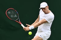 Canada's Denis Shapovalov returns the ball to France's Gregoire Barrere during their men's singles tennis match on the fourth day of the 2023 Wimbledon Championships at The All England Tennis Club in Wimbledon, southwest London, on July 6, 2023. (Photo by SEBASTIEN BOZON / AFP) / RESTRICTED TO EDITORIAL USE (Photo by SEBASTIEN BOZON/AFP via Getty Images)