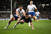 New Zealand's Rieko Ioane scores a try with Damian McKenzie during the Rugby World Cup Pool A match between New Zealand and Namibia at the Stadium de Toulouse in Toulouse, France, Friday, Sept. 15, 2023. (AP Photo/Christophe Ena)