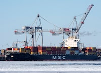 A container ship is docked in the Port of Montreal, Wednesday, February 17, 2021 in Montreal. Transport Minister Omar Alghabra says the federal government is committed to supporting the Port of Montreal as it seeks more funding for the ballooning cost of a container terminal expansion. THE CANADIAN PRESS/Ryan Remiorz