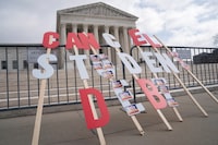 A sign calling for student loan debt relief is seen in front of the Supreme Court as the justices are scheduled to hear oral arguments in two cases involving President Joe Biden's bid to reinstate his plan to cancel billions of dollars in student debt in Washington, U.S., February 28, 2023. REUTERS/Nathan Howard