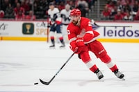 Detroit Red Wings defenceman Filip Hronek skates with the puck against the Washington Capitals during the second period of an NHL hockey game, Tuesday, Feb. 21, 2023, in Washington. The Vancouver Canucks have added to their blue line, acquiring Hronek from the Red Wings.THE CANADIAN PRESS/AP-Julio Cortez