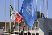 FILE - The United Nations and the Ireland flags fly at half-staff, at the UNIFIL headquarters in the southern Lebanese town of Naqoura, Lebanon, on Dec. 16, 2022 Four United Nations military observers were wounded Saturday while patrolling along the southern Lebanese border after a shell exploded near them, the U.N. peacekeeping mission in southern Lebanon said. The military observers of the United Nations Truce Supervision Organization support the U.N. peacekeeping mission in southern Lebanon, UNIFIL. (AP Photo/Mohammed Zaatari, File)