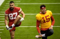 Kansas City Chiefs tight end Travis Kelce (87) and quarterback Patrick Mahomes (15) stretch during the NFL football team's practice Wednesday, Jan. 24, 2024, in Kansas City, Mo. (AP Photo/Charlie Riedel)