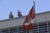 Canadian soldiers stand guard on the rooftop of their embassy in Port-au-Prince, Haiti, Wednesday, April 10, 2024. (AP Photo/Odelyn Joseph)