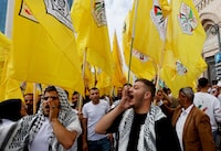 FILE PHOTO: People hold Fatah flags during a protest in support of the people of Gaza, as the conflict between Israel and Palestinian Islamist group Hamas continues, in Hebron, in the Israeli-occupied West Bank, October 27, 2023. REUTERS/Mussa Qawasma/File Photo