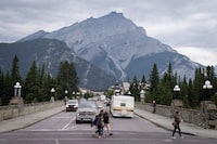 The federal government says it has completed housing agreements in six small and rural communities in Alberta, including Banff. Smoke haze from forest fires burning in Alberta and British Columbia hangs over the town in Banff National Park, Friday, July 21, 2017. THE CANADIAN PRESS/Jeff McIntosh