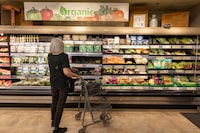 A customers looking at the organic shelfs in Farm Boy grocery stores on Bathurst , Toronto, photographed on May 31, 2023 (Ammar Bowaihl/The Globe and Mail)