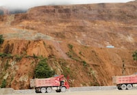 FILE PHOTO: Trucks are seen as copper output begins at the Chinese-owned Mirador mining project in Tundayme, Ecuador July 18, 2019. REUTERS/Daniel Tapia/File Photo