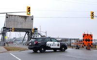 Niagara police say the lone worker hospitalized in a fire at a hazardous waste facility in St. Catharines, Ont., has died. Police block off a bridge on the Welland Canal following the early morning explosion and fire in St. Catharines, Ont., on Thursday, January 12, 2023. THE CANADIAN PRESS/Alex Lupul