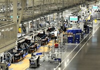 FILE PHOTO: Volkswagen employees work on the assembly line of the 2012 VW Passat in Chattanooga Tennessee, December 1, 2011. REUTERS/Billy Weeks/File Photo
