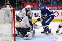 Toronto Maple Leafs left winger Michael Bunting (58) scrambles for the puck in front of Columbus Blue Jackets goaltender Elvis Merzlikins (90) during second period NHL action on Saturday, Feb. 11, 2023 in Toronto. THE CANADIAN PRESS/Jon Blacker