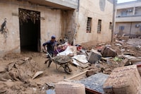 A worker cleans a house affected by fatal floods, in Derna, Libya, September 28, 2023. REUTERS/Esam Omran Al-Fetori