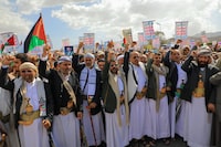 Yemenis lift placards and flags of Palestine as they march in the Huthi-run capital Sanaa on March 15, 2024, in support of Palestinians amid ongoing battles between Israel and the militant Hamas group in the Gaza Strip. A missile launched on March 15 by Yemen's Huthi rebels at a ship in the Red Sea caused no damage, after they threatened to expand their harassment campaign which has disrupted global trade. (Photo by MOHAMMED HUWAIS / AFP) (Photo by MOHAMMED HUWAIS/AFP via Getty Images)