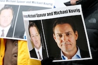 FILE PHOTO: People hold signs calling for China to release Canadian detainees Michael Spavor and Michael Kovrig during an extradition hearing for Huawei Technologies Chief Financial Officer Meng Wanzhou at the B.C. Supreme Court in Vancouver, British Columbia, Canada, March 6, 2019.  REUTERS/Lindsey Wasson/File Photo