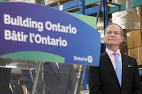 Ontario Finance Minister Peter Bethlenfalvy listens to Ontario Premier Doug Ford speak after touring the Oakville Stamping and Bending Limited facility in Oakville, Ont., on Wednesday, March 22, 2023. THE CANADIAN PRESS/Nathan Denette