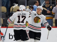 PITTSBURGH, PENNSYLVANIA - OCTOBER 10: Connor Bedard #98  and Nick Foligno #17 of the Chicago Blackhawks celebrate after a 4-2 victory against the Pittsburgh Penguins at PPG PAINTS Arena on October 10, 2023 in Pittsburgh, Pennsylvania. (Photo by Bruce Bennett/Getty Images)