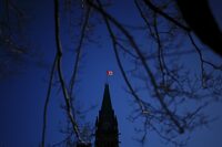 The Canada flag catches the morning light on the Peace Tower on Parliament Hill in Ottawa on Tuesday, April 16, 2024. THE CANADIAN PRESS/Sean Kilpatrick


