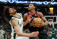 Toronto Raptors' RJ Barrett, right, drives against the Milwaukee Bucks' Andre Jackson Jr., left, during the second half of an NBA basketball game Friday, April 5, 2024, in Milwaukee. (AP Photo/Jeffrey Phelps)