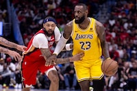 Apr 16, 2024; New Orleans, Louisiana, USA; Los Angeles Lakers forward LeBron James (23) dribbles against New Orleans Pelicans forward Brandon Ingram (14) during the second half of a play-in game of the 2024 NBA playoffs at Smoothie King Center. Mandatory Credit: Stephen Lew-USA TODAY Sports
