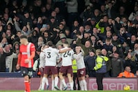 Manchester City's Jack Grealish is congratulated after scoring his side's 2nd goal during the English Premier League soccer match between Luton Town and Manchester City at Kenilworth Road stadium in Luton, England, Sunday Dec. 10, 2023. (AP Photo/Kin Cheung)