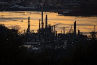 A boat travels past the Parkland Burnaby Refinery on Burrard Inlet at sunset in Burnaby, B.C., on Saturday, April 17, 2021. THE CANADIAN PRESS/Darryl Dyck