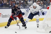 Columbus Blue Jackets' Johnny Gaudreau, left, keeps the puck away from Toronto Maple Leafs' David Kampf during the second period of an NHL hockey game Saturday, Dec. 23, 2023, in Columbus, Ohio. (AP Photo/Jay LaPrete)