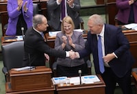 Minister of Finance Peter Bethlenfalvy, left, shakes hands with Premier Doing Ford, right, as Health Minister Sylvia Jones looks on after Bethlenfalvy tabled the Ontario provincial budget at the legislature at Queen's Park in Toronto on Tuesday, March 26, 2024. THE CANADIAN PRESS/Nathan Denette