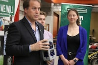 Sean Maw, principal investigator at the University of Saskatchewan College of Engineering, shows a 3D model of the RADSAT-SK cube satellite developed by students, including Rylee Moody, middle and Arliss Sidlowski, right. THE CANADIAN PRESS/Kelly Geraldine Malone