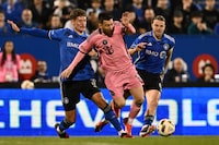 MONTREAL, QUEBEC - MAY 11: Lionel Messi #10 of Inter Miami dribbles the ball between Joaquín Sosa #3 and Samuel Piette #6 of CF Montréal during the second half at Saputo Stadium on May 11, 2024 in Montreal, Quebec. (Photo by Minas Panagiotakis/Getty Images)