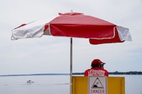 A lifeguards works at Brittany Beach of the Ottawa River in Ottawa on Friday, June 24, 2022.&nbsp;Lifesaving Society Ontario says water floaties have become a large problem this Summer, urging floaters to leave them out of open bodies of water.&nbsp;&nbsp;THE CANADIAN PRESS/Sean Kilpatrick