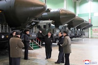 (FILES) This undated picture released from North Korea's official Korean Central News Agency (KCNA) via KNS on January 5, 2024 shows North Korea's leader Kim Jong Un (C) inspecting an important military vehicle production plant at an undisclosed location in North Korea. North Korean leader Kim Jong Un has declared the South his country's "principal enemy", jettisoned agencies dedicated to reunification and outreach, and threatened war over "even 0.001 mm" of territorial infringement. Kim said he had no intention of starting a war -- but also none of avoiding one. (Photo by KCNA VIA KNS / AFP) / South Korea OUT / REPUBLIC OF KOREA OUT - NOTE: FACES BLURRED FROM SOURCE
---EDITORS NOTE--- RESTRICTED TO EDITORIAL USE - MANDATORY CREDIT "AFP PHOTO/KCNA VIA KNS" - NO MARKETING NO ADVERTISING CAMPAIGNS - DISTRIBUTED AS A SERVICE TO CLIENTS / THIS PICTURE WAS MADE AVAILABLE BY A THIRD PARTY. AFP CAN NOT INDEPENDENTLY VERIFY THE AUTHENTICITY, LOCATION, DATE AND CONTENT OF THIS IMAGE --- /  (Photo by STR/KCNA VIA KNS/AFP via Getty Images)