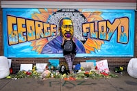 FILE - Damarra Atkins pays respect to George Floyd at a mural at George Floyd Square in Minneapolis, April 23, 2021. Tou Thao, the last former Minneapolis police officer to face sentencing in state court for his role in the killing of Floyd, will learn Monday, Aug. 7, 2023, whether he'll spend any additional time in prison. (AP Photo/Julio Cortez, File)