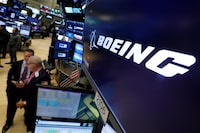 FILE - The logo for Boeing appears above a trading post on the floor of the New York Stock Exchange, Oct. 24, 2018. Boeing CEO David Calhoun received compensation valued at $33 million in 2023, nearly all of it in stock awards, but his stock payout for this year will be cut by nearly one-fourth because of the drop in Boeing’s share price since the January 2024 blowout of a panel on one of its planes in midflight. (AP Photo/Richard Drew, File)