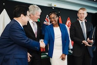 Kemi Badenoch, British Trade Minister, second right, shakes hands with Japan's Minister of Economic & Fiscal Policy Shigeyuki Goto, left, as New Zealand Minister for Trade and Export Growth Damien O'Connor, and New Zealand Prime Minister Chris Hipkins, right, watch during the Trans-Pacific Partnership (TPP) Ministerial Meeting in Auckland, New Zealand, Sunday, July 16, 2023. Britain on Sunday officially joined an Asia-Pacific trade group that includes Japan and 10 other nations during a meeting in New Zealand. (Smoke Photography via AP)