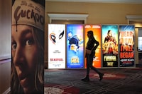 A visitor walks past advertisements for upcoming movies on the opening day of CinemaCon 2024 at Caesars Palace, Monday, April 8, 2024, in Las Vegas. The four-day convention of the National Association of Theatre Owners (NATO) runs through Thursday. (AP Photo/Chris Pizzello)
