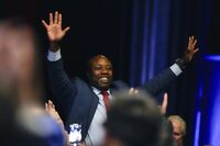 Sen. Tim Scott, R-S.C., waves as Republican presidential candidate former President Donald Trump speaks during a Fox News Channel town Hall Tuesday, Feb. 20, 2024, in Greenville, S.C. (AP Photo/Chris Carlson)