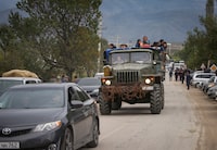 Refugees from Nagorno-Karabakh region arrive by truck in the border village of Kornidzor, Armenia, September 26, 2023. REUTERS/Irakli Gedenidze
