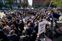 File - Reporters surround attorneys for Dominion Voting Systems during a news conference outside the New Castle County Courthouse in Wilmington, Del., after the defamation lawsuit by Dominion against Fox News was settled on Tuesday, April 18, 2023. Fox Corp.'s hefty $787.5 million settlement with Dominion over defamation charges is unlikely to make a dent in Fox's operations, analysts say. (AP Photo/Julio Cortez, File)