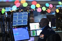 Traders work on the floor of the New York Stock Exchange (NYSE) during morning trading on Dec. 14.