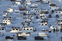 There will be no colourful ice fishing huts dotting the bay near Saguenay, Que., this year, due to warm winter weather that forced the city to cancel the popular tradition for the first time. An overall view of some the more than 350 ice fishing cabins on the Ste-Anne river in Ste-Anne-de-la-Pérade, Quebec on Sunday, January 15, 2023. THE CANADIAN PRESS/Bernard Brault